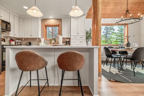 Enjoy high top seating for two at the kitchen bar or seating for six around the dinner table