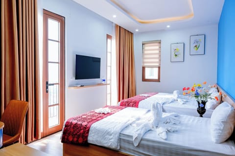 Deluxe Triple Room, Partial Ocean View | In-room safe, desk, laptop workspace, free WiFi