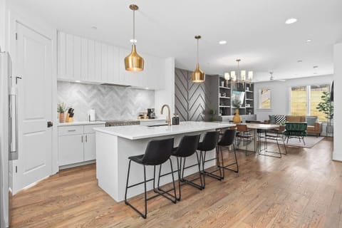 High-end appliances, large pantry, and all the cooking supplies you might need in this bright & refreshing kitchen with seating for four at the island.