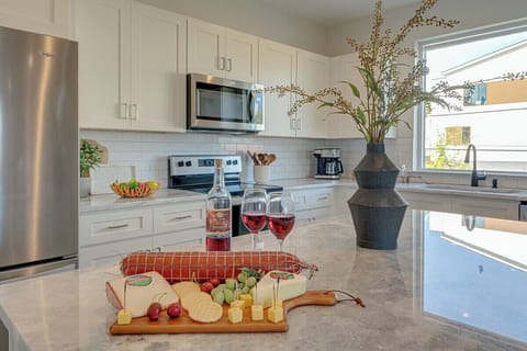 Fully equipped kitchen stocked with basic cooking essentials and stainless steel appliances.