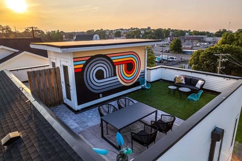 Private rooftop deck outdoor dining table (seats 4) and lounge area. Entire space is lined with bistro lights and includes a photo op mural!