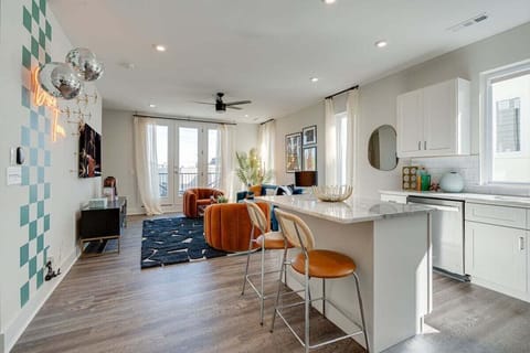 Bright and open kitchen equipped with stainless steel appliances and is fully stocked with your basic cooking essentials. Features breakfast bar seating and connects to living space.