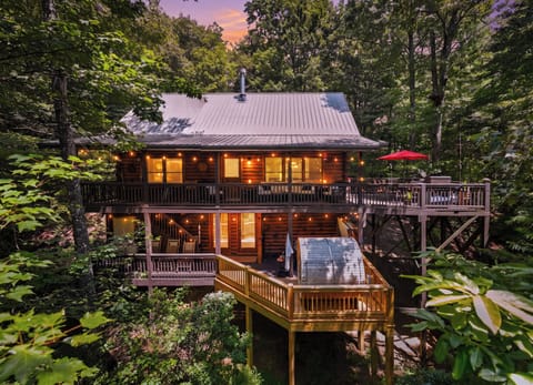 Cedar Stone Retreat at dusk — where the woods come alive & the cabin glows warm.