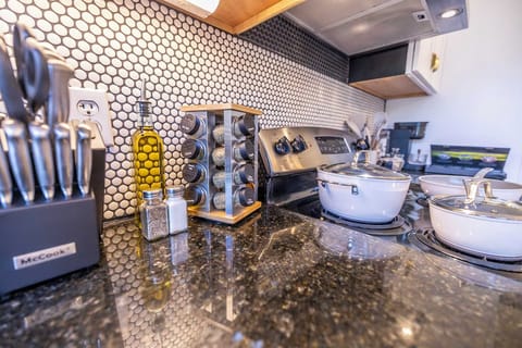 Whip up delicious meals with ease in our gourmet kitchen, equipped with high-end appliances and chic cookware. From the organized spice rack to the professional knife set, every detail is designed for culinary enthusiasts.