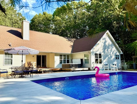 Large heated pool with stairs for easy access, seating bench and splash area