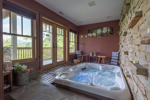 Indulge in relaxation in the sunroom, boasting an indoor hot tub where you can soak while enjoying the surrounding views.