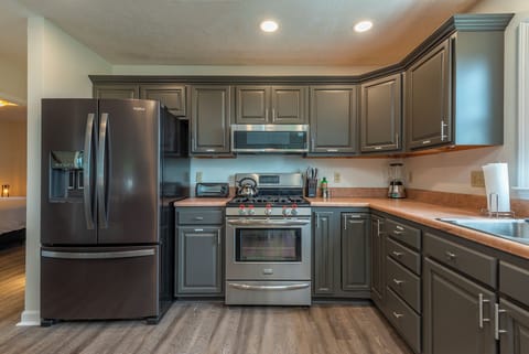 Well-equipped kitchen with gas range, dishwasher, and coffee bar with standard, drip-style coffee maker and Keurig