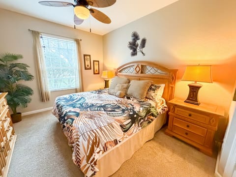 Master bedroom showing king bed, bedside tables and lighting.