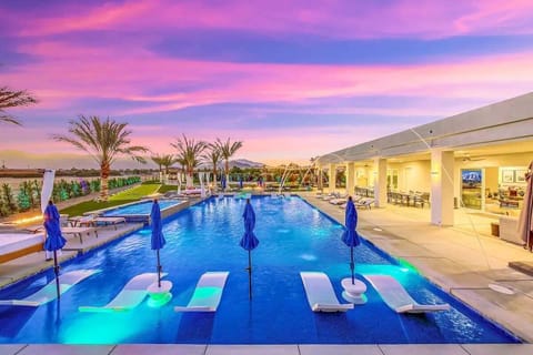 Relax and cool off on submerged loungers in the tranquil pool, surrounded by vivid desert skies.