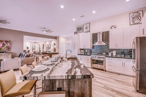 Chic and functional kitchen with bar seating and ample space for preparing and serving meals.