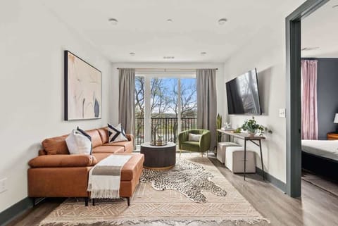 The Spacious Living Room Features An Oversized Couch & TV