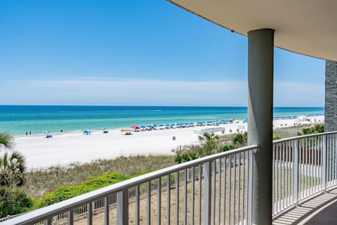 Stunning beachfront balcony overlooking pristine white sand and turquoise waters where you can watch beach activities unfold.