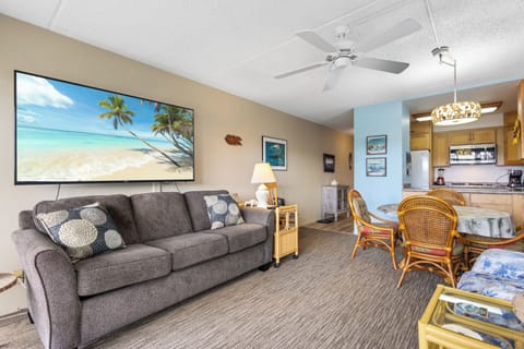 Unwind in your coastal retreat where a plush sofa, tropical décor, and open-concept design invite you to relax after a day at the beach.