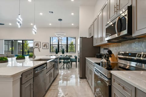 Modern chef’s kitchen with stainless steel appliances and sleek quartz countertops.