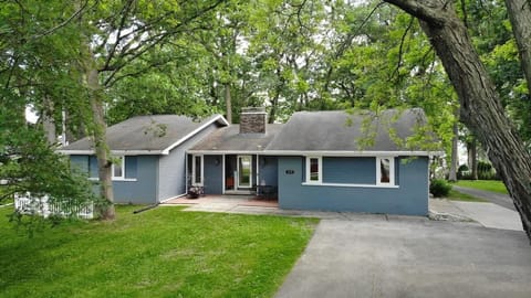 Front of home with private driveway, giving privacy from surrounding trees. This includes parking spaces for multiple vehicles and horseshoe driveway. 
