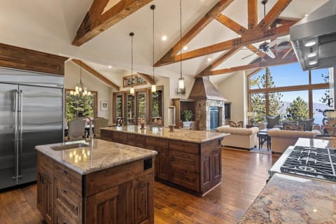 Cook and entertain in style in this spacious kitchen, complete with a grand island and rustic wooden beams.