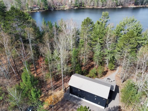 A stunning two-story home nestled in a picturesque woodland setting.