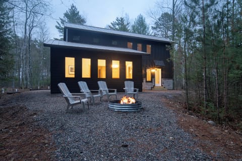 Unwind near the fire pit surrounded by comfortable Adirondack chairs.