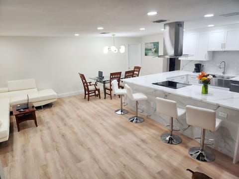 Spacious open floor with Chef's Kitchen and white quartz countertops.