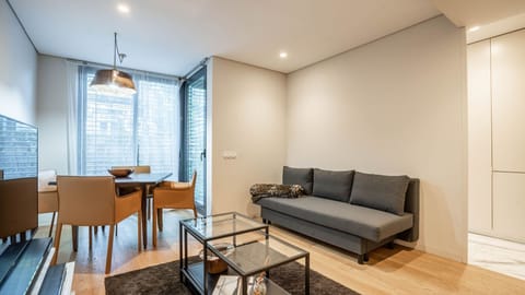 Unwind in the stylish living room adorned with modern furnishings and ample natural light. #ComfortAndStyle #HomeAwayFromHome