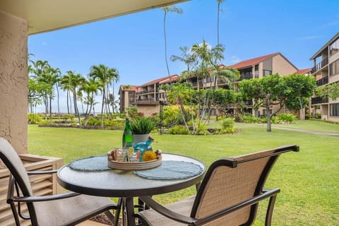 Sip drinks on patios where lawns stretch to palms.