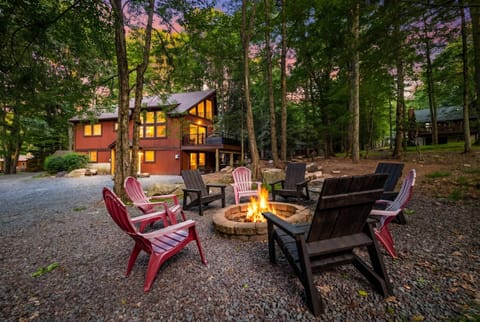 Pull up as dusk settles over the Poconos and find your cabin already glowing, chairs pulled around a crackling fire pit waiting for the first night's stories.