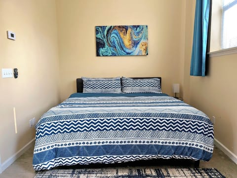 This king-sized bedroom offers the perfect retreat for relaxation and comfort.
