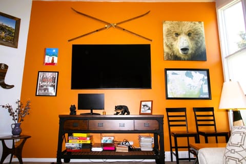 Large living room with 80" Smart TV, board games, puzzles