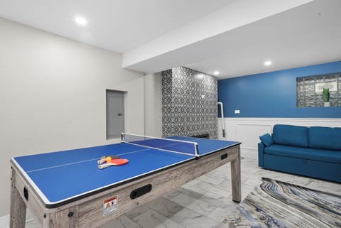 Basement Game Area with 75 Inch Samsung 4K TVs, Games, Sleeper Sofas, Fireplace