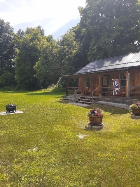 Covered front porch, large lawn, fire pit. Enjoy sunrises and watching wildlife.