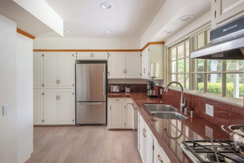 Full kitchen with oven stove, fridge and dishwasher.