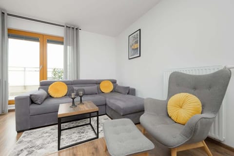 A cosy lounge area with a large window letting in natural light creates the perfect spot to relax with a cup of coffee.