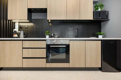 The sleek design of the kitchenette blending seamlessly with the living area.