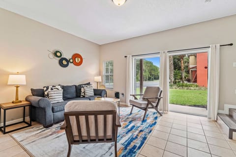 Relax and unwind in inviting and spacious living area of the townhouse in Kissimmee Florida - Cozy seating encourages relaxation and socializing, designed to be both inviting and relaxing - Easy access to outdoors though the sliding glass door