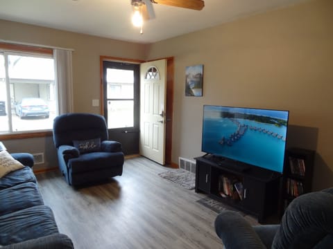 Living room with Roku TV, couch, and recliners