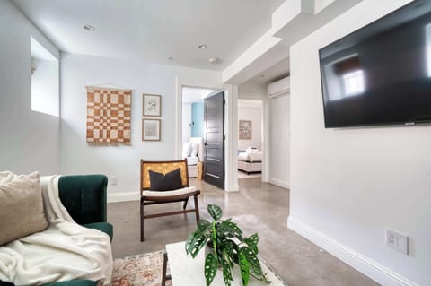 Living room with seating and hallway view.