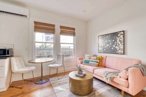Living area with pink sofa and bistro table.