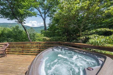 Spacious upper deck features a hot tub and seating area—the ideal spot to soak while gazing across the Seven Sisters mountain range.