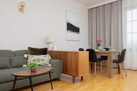 A cosy living room with a comfortable sofa and wooden table creates the perfect space for both relaxation and shared meals.