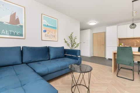 The living room offers a bright and airy space for relaxation.