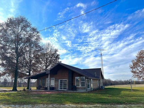 Back of cabin. Great place to sit in the shade, BBQ, or set by the propane fire pit!