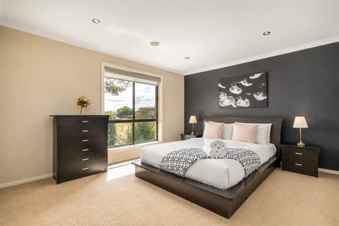 Retreat to the spacious bedroom, featuring a plush queen bed, soft linens and plenty of natural light—your perfect place to unwind after a day of exploring.