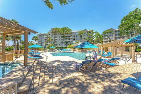 Large pool, expansive sun decks, and shaded seating areas create an ideal setting for relaxing between beach walks.