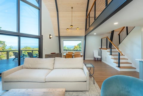 Open living and dining area with floor-to-ceiling mountain views.