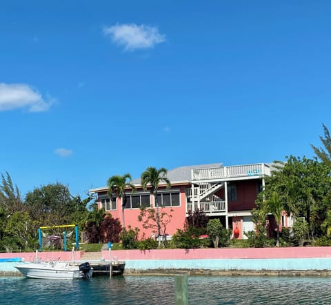 Back of house showing backyard, bulkhead, dock, and roof top deck. 