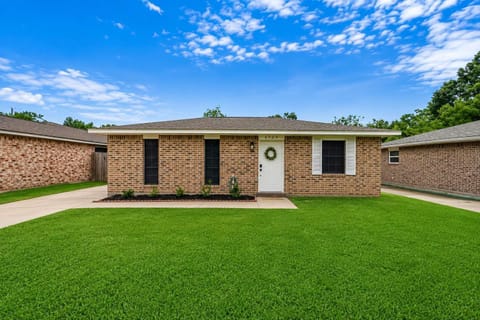 Exterior: Charming brick facade with lush greenery and a welcoming entryway awaits your stay!