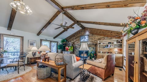 Second living room with wood burning fireplace and TV