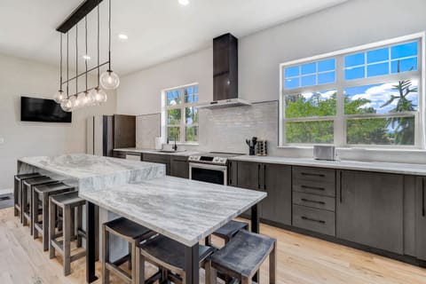 Modern kitchen with a large island, ample seating, and stainless steel appliances, perfect for cooking and entertaining.