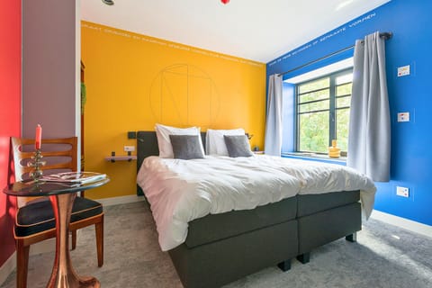 Vibrant and cozy bedroom featuring bold colors and stylish decor.
Stay central and save money at Hotel Tilburg! Ideal for Efteling adventures, Beekse Bergen trips, or exploring Tilburg itself.