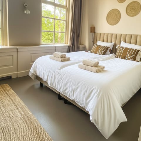 Relax in this cozy bed at Bed en Koffie Zoutelande. Perfect for couples or family retreat.